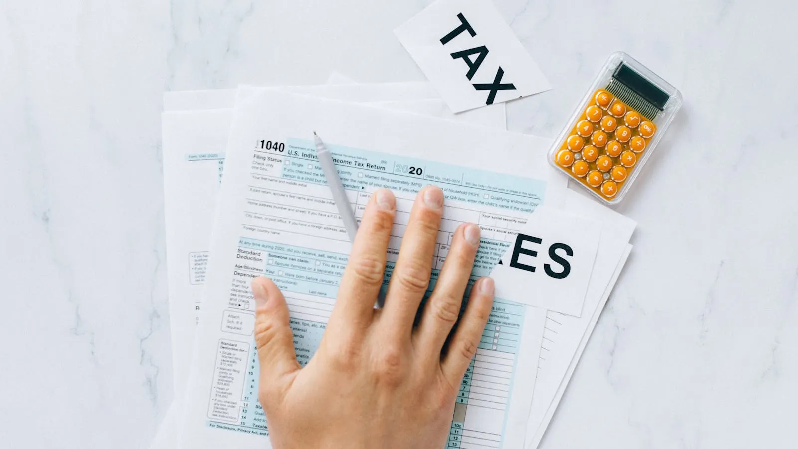 Tax documents and calculator on an accounting desk